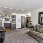 The open living room and kitchen in a two bedroom apartment