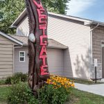 Carved tree trunk with WESTGATE sign
